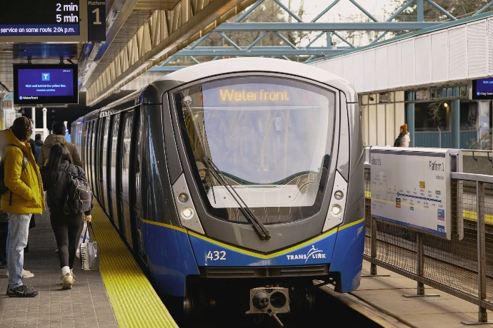 Modern train at a station platform with passengers